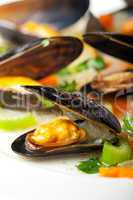 cooked mussels and vegetables with wine sauce