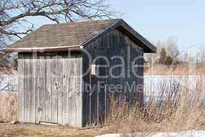 Old Weathered Board and Batten Shed with Birdhouse