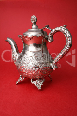 Elegant retro kettle on red background