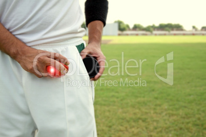 Bowler shining the ball from shoe polish