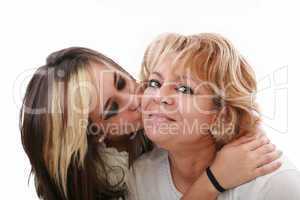 Closeup of young girl kissing her mom isolated on a white backgr