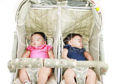 twins sleeping in their stroller