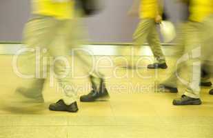 manual workers walking by in a building