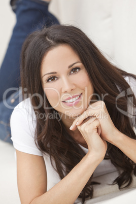 Happy Smiling Beautiful Woman Laying on Sofa