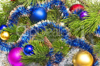 Pine branch with Christmas decorations in the background