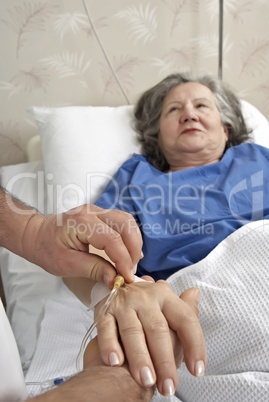 Adult helping senior in hospital