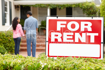 Hispanic couple outside home for rent