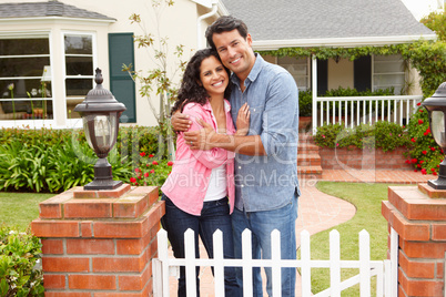 Hispanic couple outside home