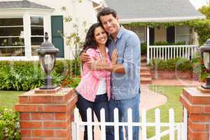 Hispanic couple outside home