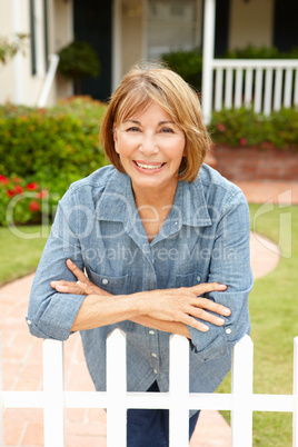 Senior Hispanic woman outside home
