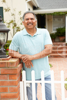 Senior Hispanic man outside home