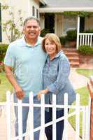 Senior Hispanic couple outside home