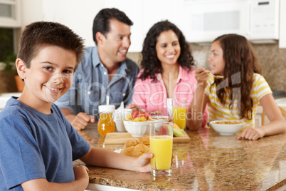 Hispanic family eating breakfast