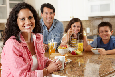 Hispanic family eating breakfast