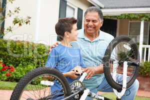 boy and grandfather fixing bike