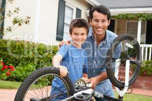 Father and son fixing bike