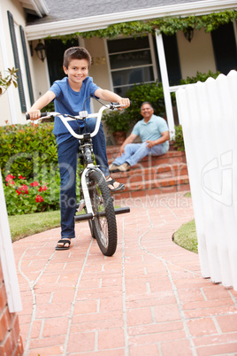 Boy and grandfather at home with bike