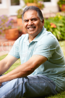 Mid age man relaxing in garden