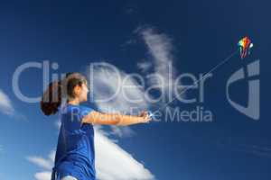 Teenage girl flying a kite