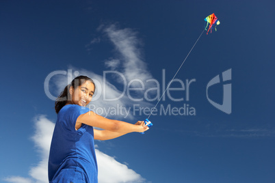 Teenage girl flying a kite