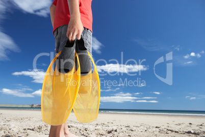 Teenage boy on beach with flippers