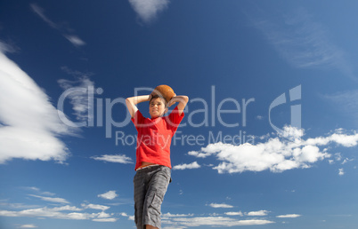 Teenage boy throwing football