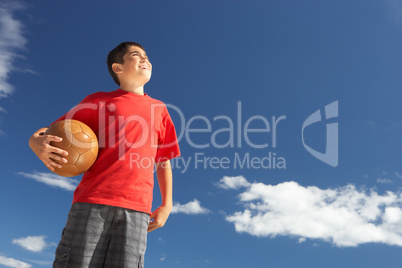 Teenage boy holding football