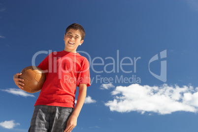 Teenage boy holding football