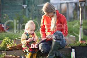 Woman and child with picnic on allotment