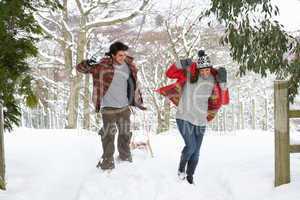 Young couple having snowball fight