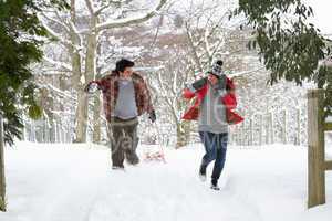 Young couple having snowball fight