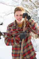 Young man clearing snow