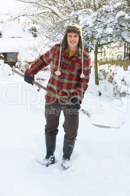 Young man clearing snow