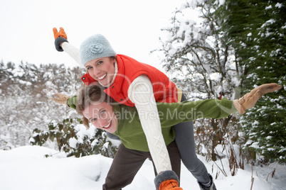 Young couple having fun in snow