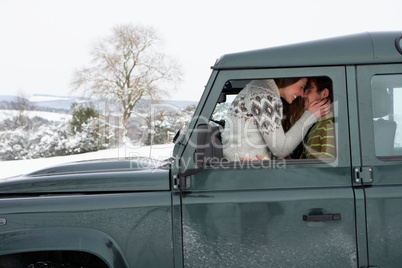 Young couple in car in snow