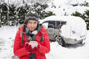 Young woman in snow with car