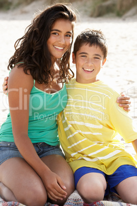 Portrait teenage brother and sister on beach