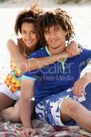 Portrait teenage couple on beach