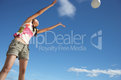 Teenage girl throwing ball