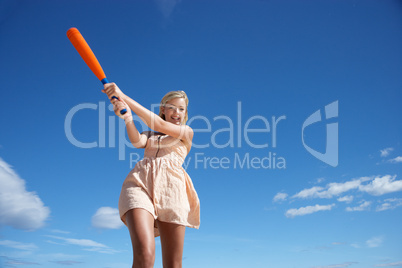 Teenage girl playing baseball