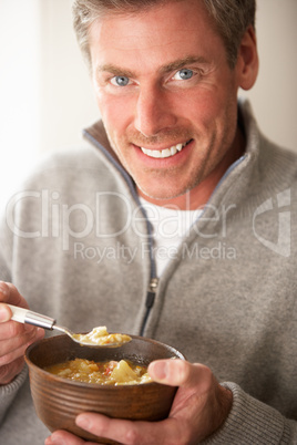 Man eating bowl of soup