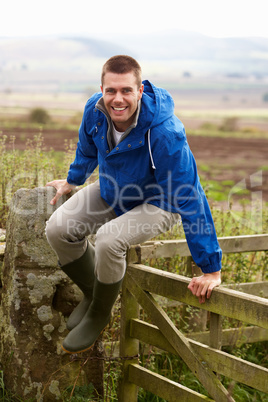 Man jumping over country gate