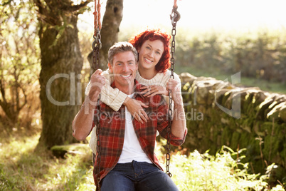 Couple with country garden swing
