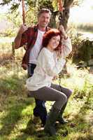 Couple with country garden swing