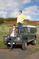 Young couple in countryside with SUV