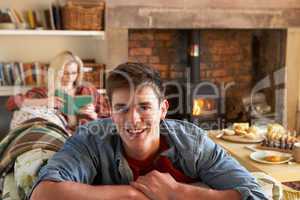 Young couple relaxing by fire