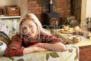 Young woman relaxing by fire