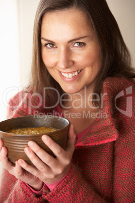 Woman holding bowl of soup