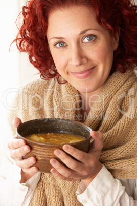 Woman holding bowl of soup