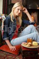 Young woman making toast on open fire